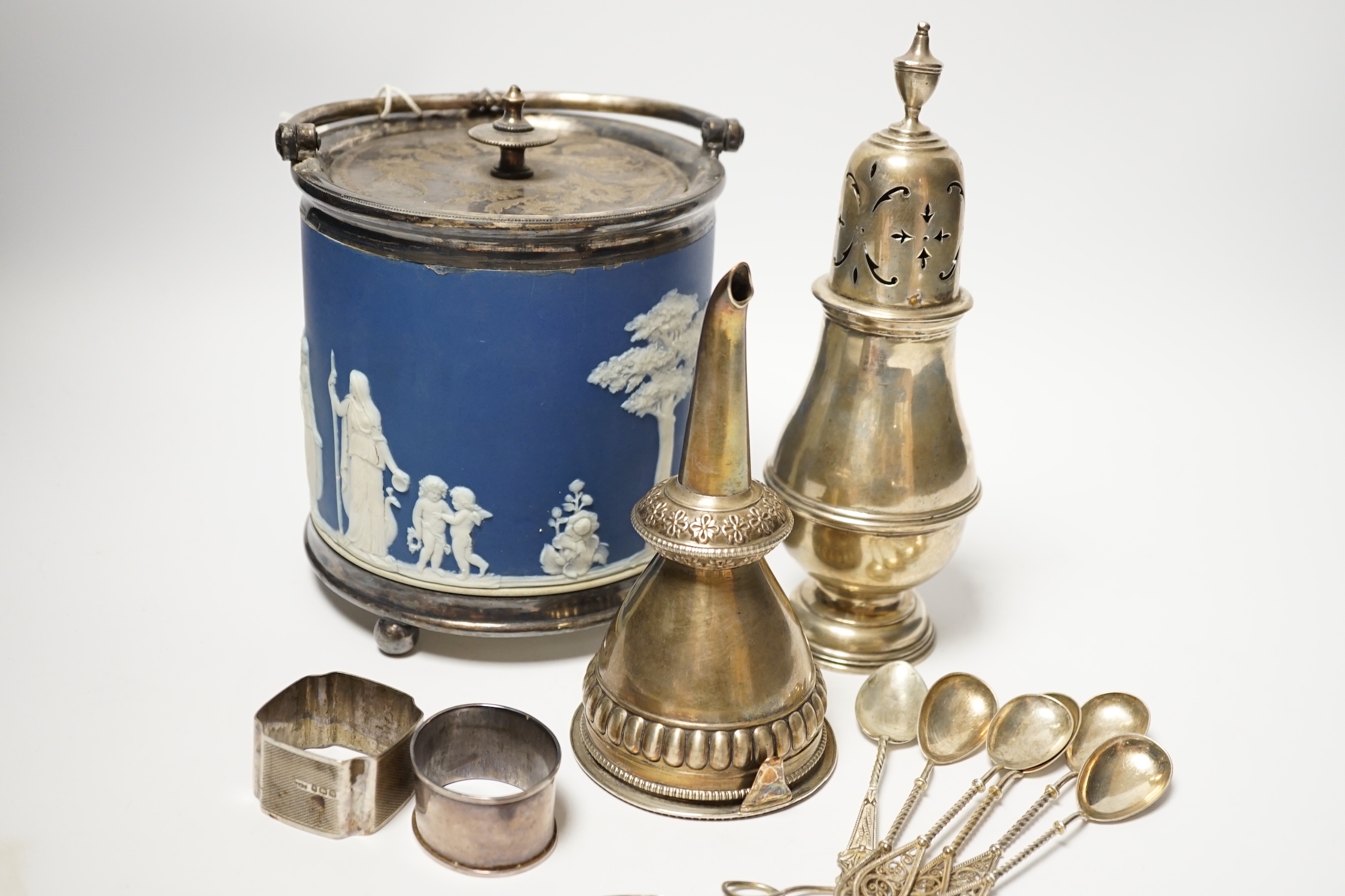 A silver sugar caster, serviette rings, a plated wine funnel, a Wedgwood biscuit barrel, etc.